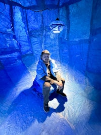 a man sitting in a blue room